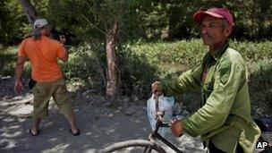 A journalist films the tree which Mr Paya's car hit on Sunday