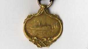 Front of a gold Carpathia medal