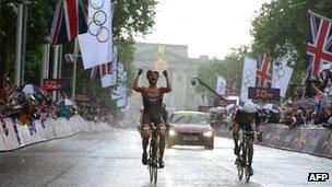 Marianne Vos celebrates as she crosses the finish, followed by Lizzie Armitstead