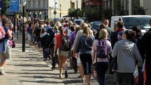 Spectators make their way through Greenwich on Monday