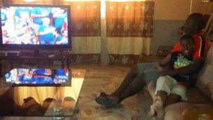 Gabriel Asiamah and his sister watching London 2012 on TV in West Africa