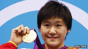 China's Ye Shiwen poses with her gold medal for the women's 400m individual medley at the London 2012 Olympic Games at the Aquatics Centre 28 July, 2012