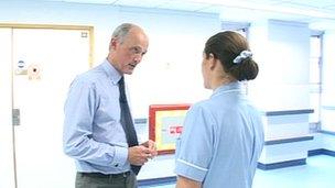 Derriford Hospital chairman Richard Crompton talks to a nurse