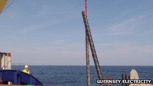 Electricity cable being winched on deck