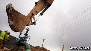 Men work on a natural gas valve at a hydraulic fracturing site South Montrose, Pennsylvania.