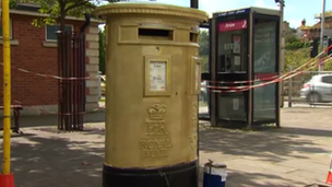 The Wrexham post box being painted gold in honour of rower Tom James' Olympic victory