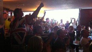 Crowd watching Olympics in pub