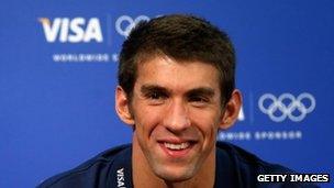 A Visa logo in the background as US swimmer Michael Phelps speaks to the media