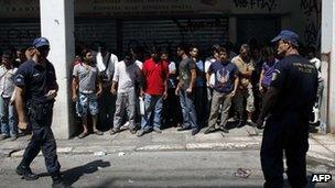 Police detain a group of immigrants in central Athens on August 5, 2012