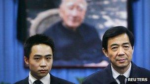 China's former Chongqing Municipality Communist Party Secretary Bo Xilai (R) and his son Bo Guagua stand in front of a picture of his father Bo Yibo in a file photo 18 January, 2007