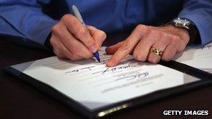 Man's hands sign bill