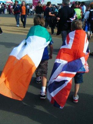 Child wrapped in Irish tricolour, another wrapped in Union flag