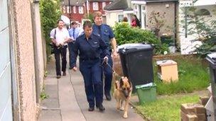 A police dog is taken to the home of Christine Sharp