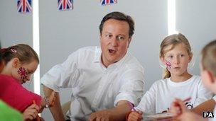 Prime Minister David Cameron meets children at a sports camp during a visit to the Scotstoun Stadium in Glasgow