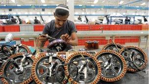 An Indian woman at work in a coil factory