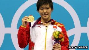 Gold medallist Shiwen Ye of China poses on the podium during the medal ceremony in the Women"s 200m Individual Medley final