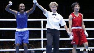 Nicola Adams, left, reacts as she is declared the winner over China's Ren Cancan during their Women's Fly gold medal boxing match