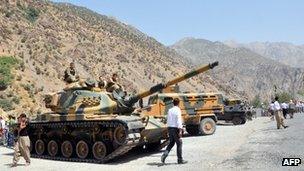 Heavy armoured vehicles of Turkish military are stationed in front of Gecimli military outpost on 5 August 2012 at Cukurca in Hakkari