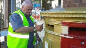 Post box painted gold in Flint