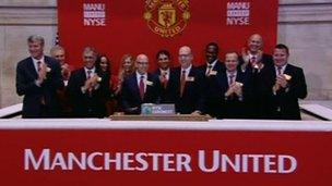 Manchester United executives ring the opening bell at the New York Stock Exchange