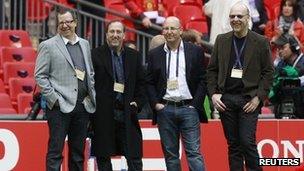 Manchester United board members Brian (L), Joel (2nd R) and Avram Glazer (R) watch their players during a training session at Wembley Stadium in London in this May 27, 2011