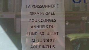 A sign in the fishmongers saying the will be closed from 30 July to 27 August