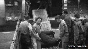 The first load of coal to be delivered by air as part of the Berlin airlift arrives at Tempelhof Airport