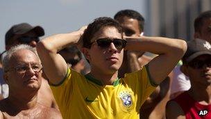 Brazil fans on Copacabana beach in Rio react as their team is defeated at the Olympics final