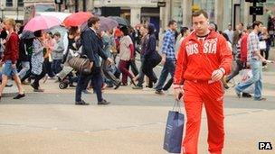 A man in a Russia Olympic tracksuit shops on Oxford Street