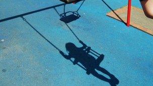 Shadow of child on swing