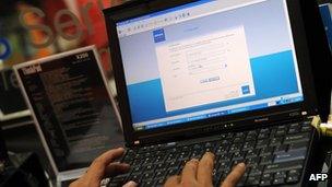 A consumer using a laptop to connect to the internet in Malaysia