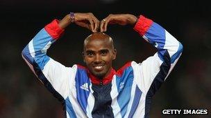 Gold medallist in the men's 5,000m Mo Farah of Great Britain celebrates on the podium (11 August)