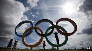 Children play on the Olympic rings at the rowing venue in Eton Dorney, near Windsor, England