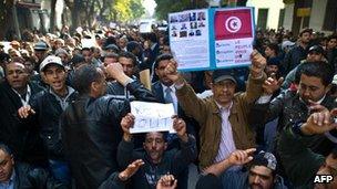 Protesters in Tunis holding placards