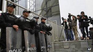 Police and media outside the British Embassy in Quito, Ecuador