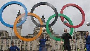 The Olympic rings outside Cardiff City Hall with footballers