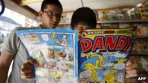 Comic book fans read a copy of The Dandy in a newsagents