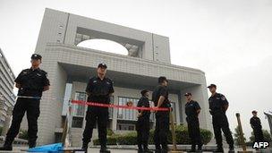 Police outside the court in Hefei on 10 August