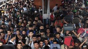 Indians originally from the northeastern states crowd as they disembark from a train originating in the southern city of Bangalore, in Gauhati, Assam state, India, Saturday, Aug. 18, 2012