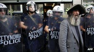Greek elderly man with riot police