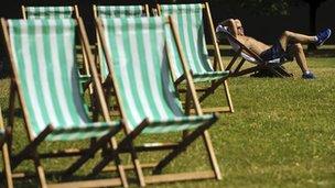 A man sunbathes in Hyde Park on August 18, 2012