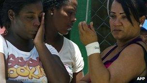 Relatives of inmates wait for news outside the Yare I prison on 20 August 2012