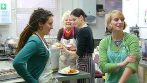 Volunteers prepare meals for clients at Catching Lives