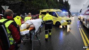 Rescuers with wounded woman after Utoeya shootings, 23 Jul 11