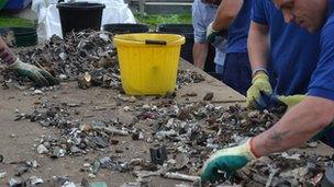 Prisoners sorting metal waste