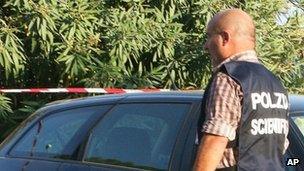 An Italian detective stands by the body of Gaetano Marino in Terracina, 23 August