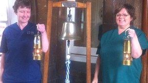 Sister Margo Lord [L] and Miriam Jenkins with the flame at Rookwood Hospital, Llandaff