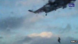 Man winched on to helicopter. Pic: RNLI