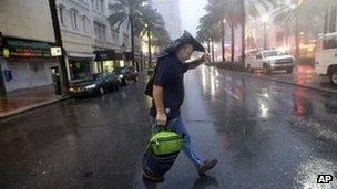 Ronnie Willis makes his way across Canal Street through the wind and rain from Hurricane Isaac in New Orleans 29 August 2012