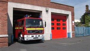 A fire engine leaving a fire station